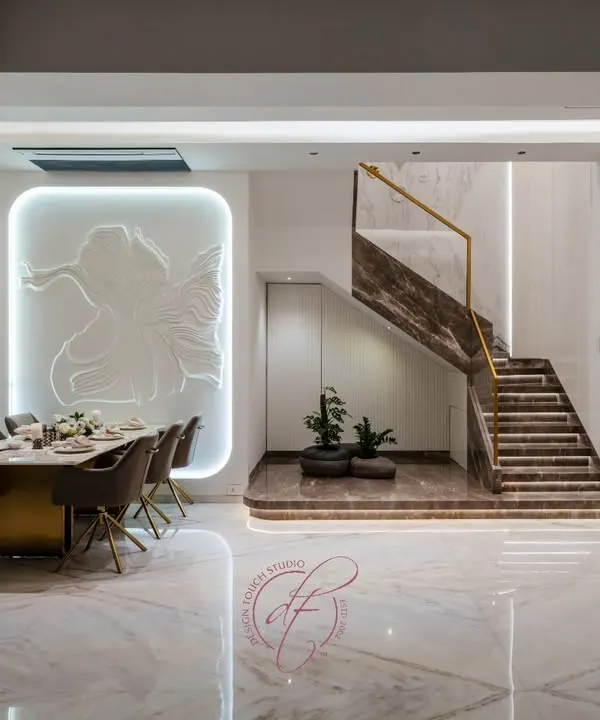 This duplex home is a symphony of modern elegance. The grand marble staircase with integrated lighting and the bespoke 3D wall art create a breathtaking first impression, showcasing our ability to craft large-scale, luxurious residential interiors.