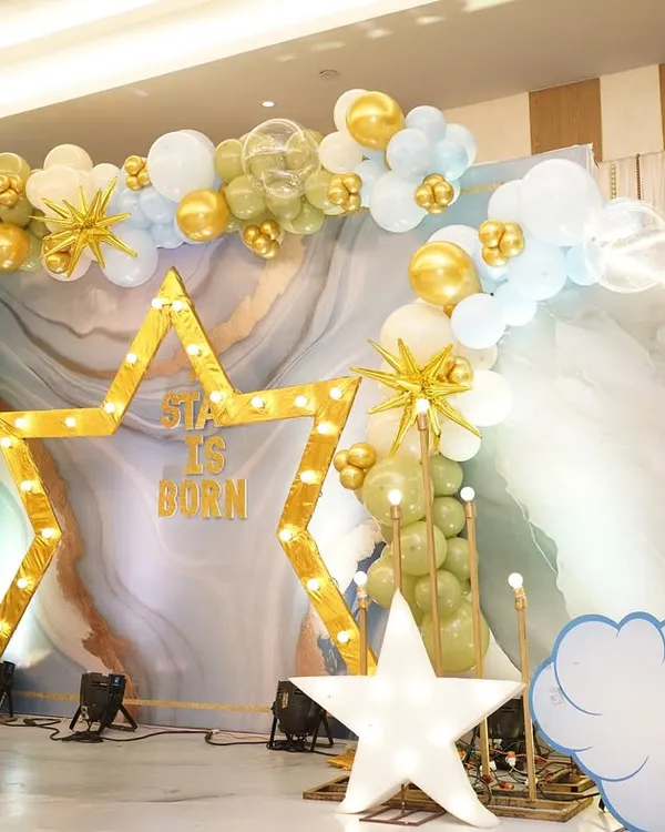 A stunning wide shot of our 'A Star Is Born' naming ceremony decor. The marquee star, crescent moon, and cloud cutouts against a marble-effect backdrop create a truly celestial and magical setting.