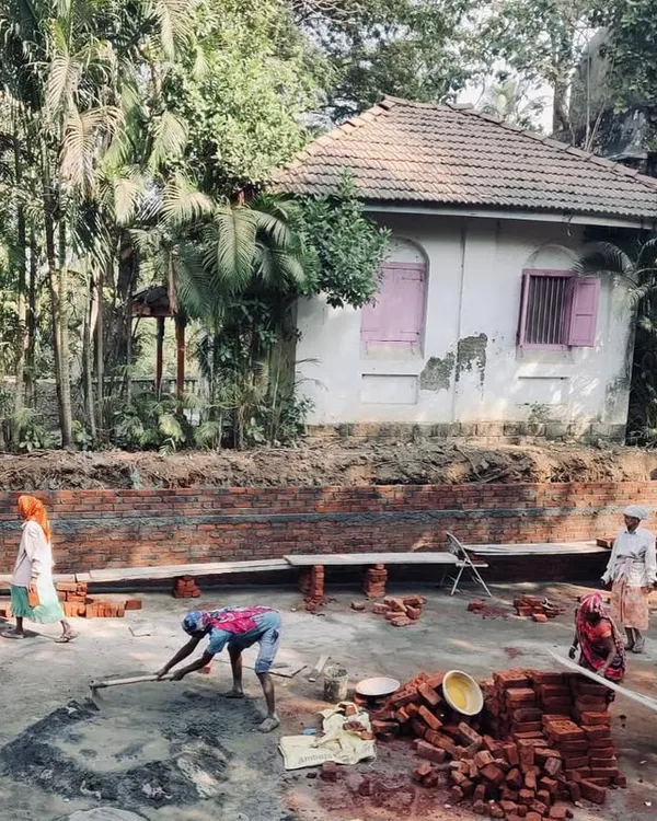 A team of masons at work laying bricks for a new foundation wall at one of our Alibaug sites. This foundational work is critical for ensuring the longevity of the structures we restore and build.