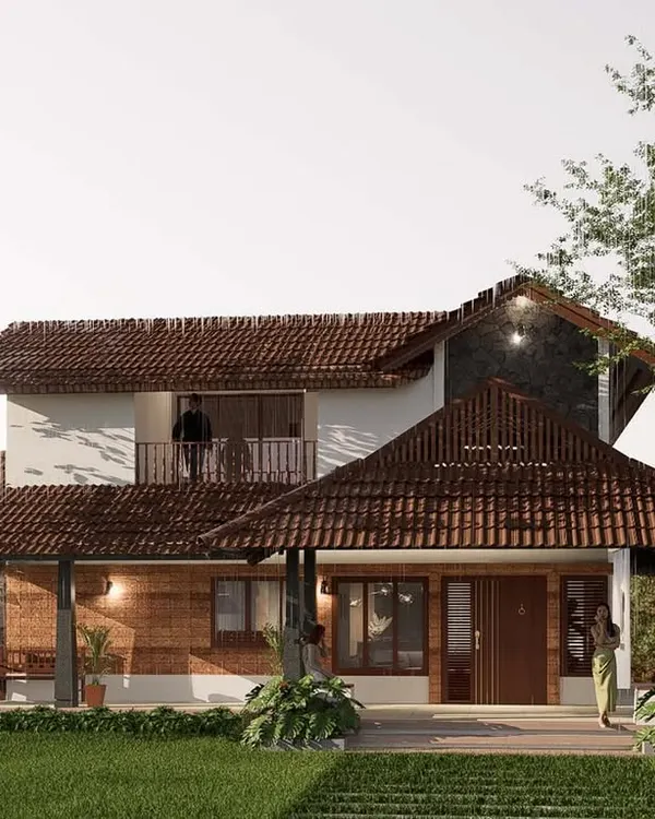 This view of a vernacular-style home highlights the use of a prominent tiled gable roof and stone-clad walls. The design provides deep, shaded verandas that serve as a transition between the interior and the garden, ideal for a tropical climate.