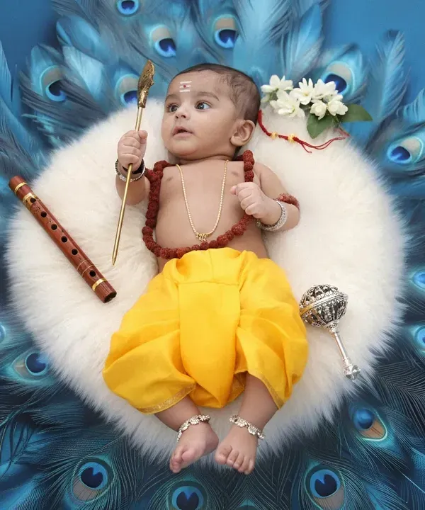 This portrait captures the divine innocence of a child dressed as Lord Muruga, set against a backdrop of vibrant peacock feathers. We pay close attention to every detail, from the traditional attire to the gentle expression, to create a truly special keepsake.