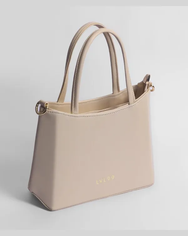 A clean, elegant shot of a beige women's handbag. This 3/4 view is perfect for showcasing the bag's shape and structure.