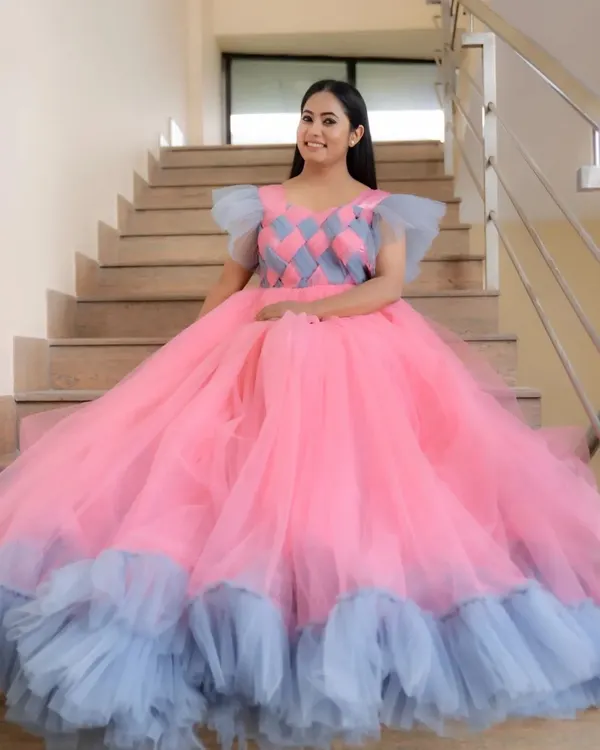 A full view of our custom-made pink and grey ball gown, featuring a unique checkered bodice and a voluminous tulle skirt. This gown is perfect for making a grand statement.
