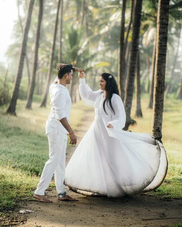 A candid moment of dance and laughter, captured amidst the serene beauty of a sunlit forest. We believe the best photos happen when you forget we're even there, lost in the happiness of the moment. This is the kind of natural, joyful pre-wedding photography we love to create.