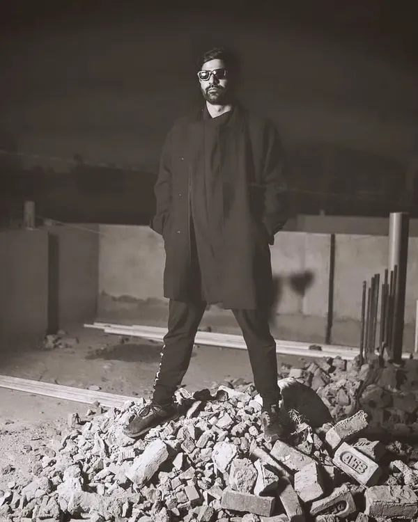 Standing on a pile of rubble, a metaphor for building something new from the ground up. This shot captures the raw, industrial edge of my techno sound.