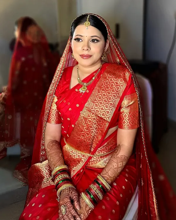 The making of a Maharashtrian bride. This look features the traditional 'Chandrakor' bindi, a neat bun for the 'mundavalya', and makeup that complements the rich texture of a Paithani saree.