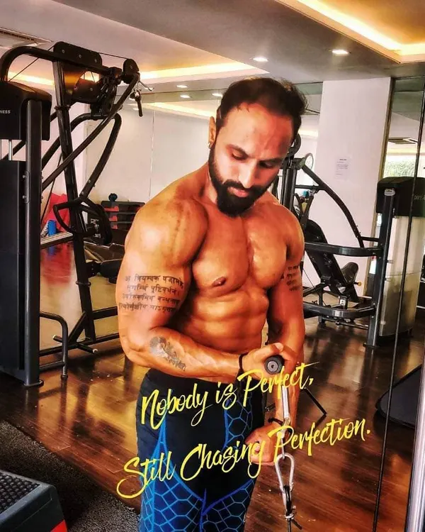Focus and intensity during a bicep curl session at the gym. Professional equipment like this SportsArt machine allows for perfect muscle isolation, but the real work comes from your mind-muscle connection.