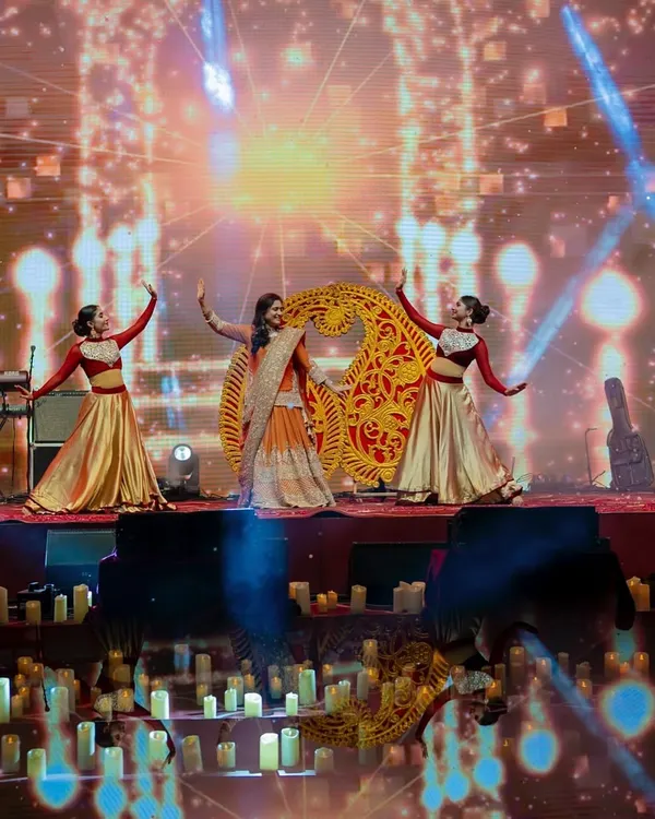 For this 'Chandni Ratein' Sufi-themed sangeet, we used paisley-shaped props and a warm, golden color palette to create a rich and traditional atmosphere. The stage was lit with hundreds of candles to enhance the theme.