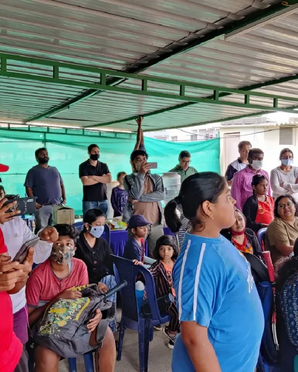 Spectators and players watch intently from the shaded viewing gallery during one of our academy events. This space provides a comfortable spot for parents and friends to support the players on court.