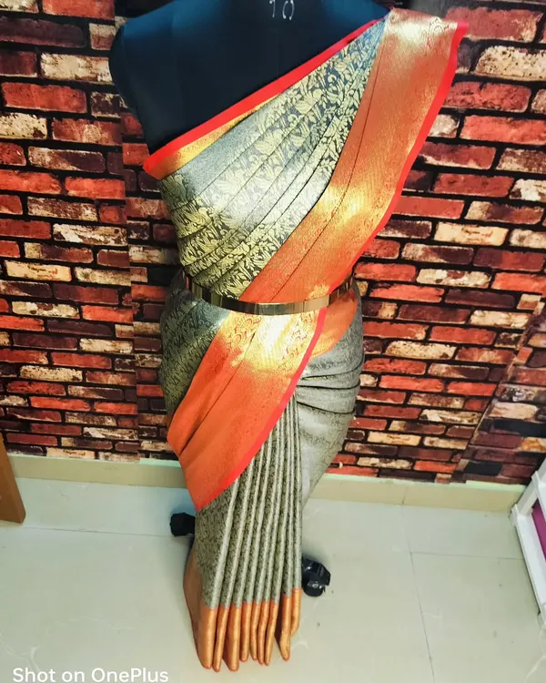 This is the final draped look with fluffy pleats on a mannequin. A waist belt adds a modern touch to the traditional drape.