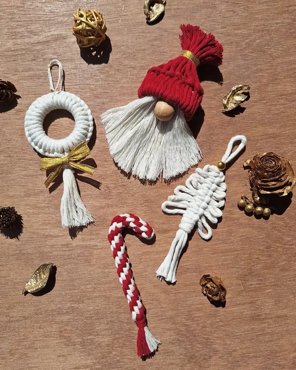Get your jingle on with these handmade macrame ornaments. This set includes a Santa gnome, a candy cane, a wreath, and a tree, perfect for adding a boho touch to your Christmas tree.