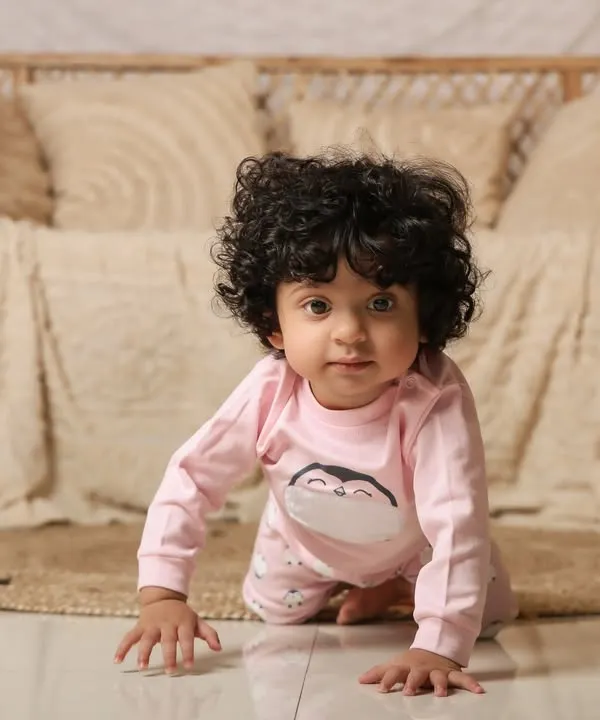 A sweet baby girl crawling in our cozy boho setup. The neutral tones and soft textures create a warm and inviting portrait.