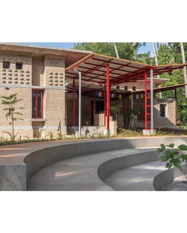 This is our zero-footprint administrative office in Karnataka, built for the Tibetan community. The edifice is constructed from mud bricks made on-site and features a central courtyard, demonstrating our principles of using local materials and creating climate-responsive, communal spaces.