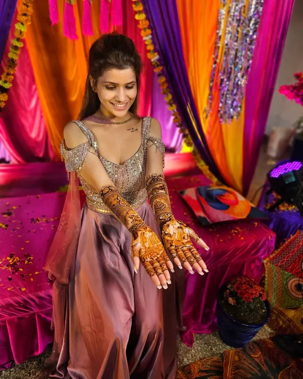 A beautiful bride smiling as she shows off her full bridal mehndi. It's an honor to be a part of such a special day.