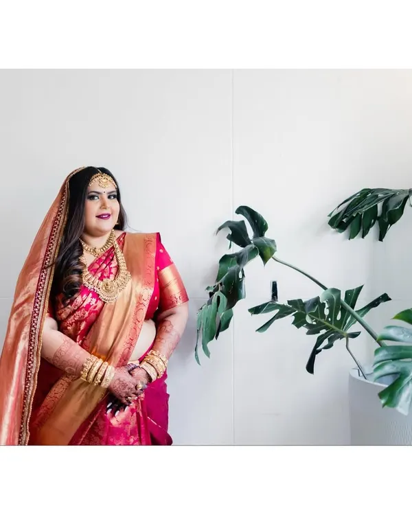 The bride, Ruchi, looking absolutely regal in her red and gold Kanjeevaram saree from Angadi. We paired it with traditional temple jewelry to create a classic and stunning Mallu bridal look.