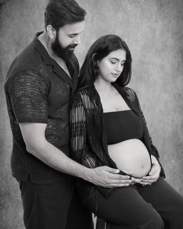 In this intimate black and white portrait, I captured the quiet promise between two parents-to-be, their hands joined over the life they created together.