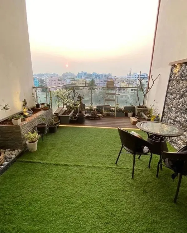 We converted this entire high-rise balcony into a complete garden retreat. The design incorporates artificial turf for a touch of green, a gabion feature wall, a stone-clad planter with a water feature, and a comfortable seating area to enjoy the sunset.