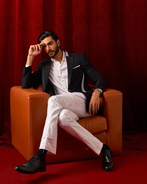 A classic black blazer with modern white striped details. Paired with a crisp white shirt and trousers, this is a powerful look for any formal setting.