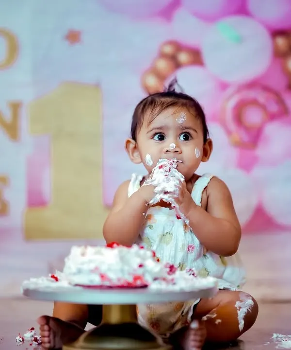 This is what pure first-birthday joy looks like. Our cake smash setup is one of our most popular, providing a fun, messy, and memorable way to celebrate that big "ONE" milestone. The pink balloon and dessert-themed backdrop is fully prepared for your little one's big day.
