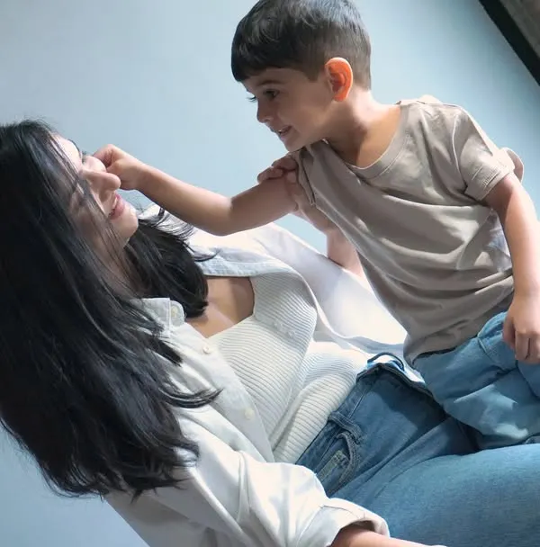 A candid, heartwarming moment between a mother and her son, showcasing a natural and playful interaction. This is an example of our "mom & me" family bonding photo sessions.