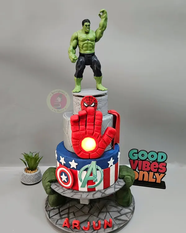 This Avengers-themed anti-gravity cake is a feat of engineering and artistry. Featuring a light-up Iron Man hand and the Hulk's fists supporting a tier, it's a superhero dream come true for any fan.