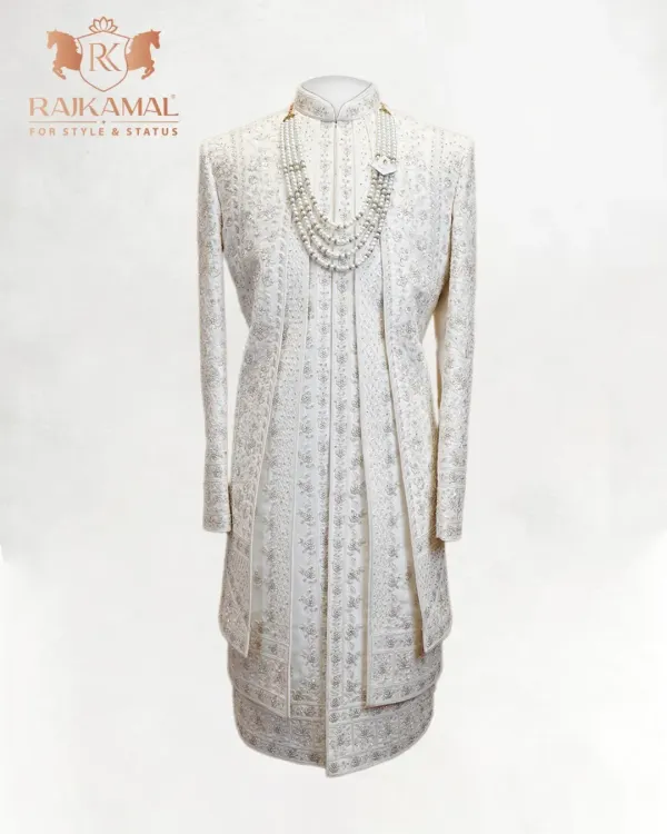 A complete view of my classic ivory sherwani, featuring subtle all-over embroidery and paired with a multi-layered pearl necklace. This is a look designed for the groom who desires pure, understated elegance.