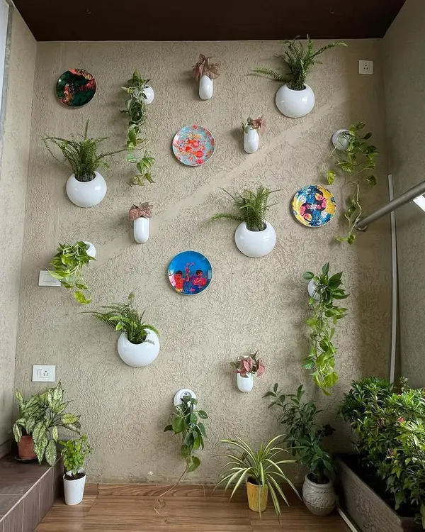 For this balcony, we used a creative mix of wall-mounted planters and decorative plates to create an artistic feature wall. This approach adds greenery without taking up any floor space, keeping the balcony open and uncluttered.