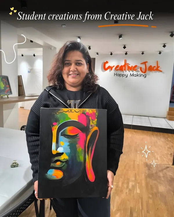 A proud student showcasing her vibrant, multi-colored Buddha canvas painting. This is what happens when you let your creativity flow in my guided workshops.