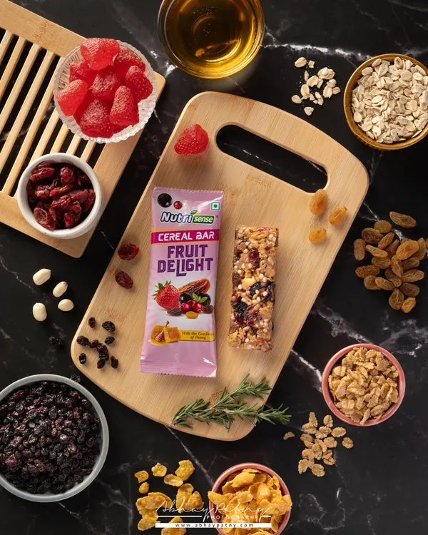 For this cereal bar, I created a flat lay that deconstructs the product, showing all the healthy and delicious ingredients inside. This visual storytelling is very effective for health-conscious brands.