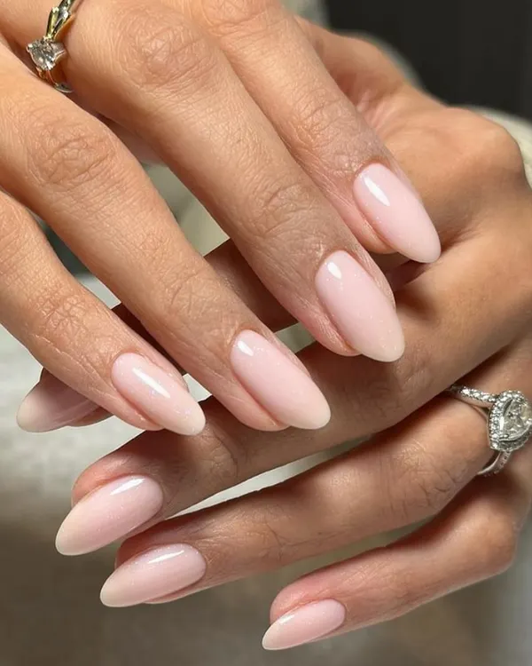 A classic and sophisticated look, these sheer pink almond nails are the perfect complement to a beautiful diamond ring.
