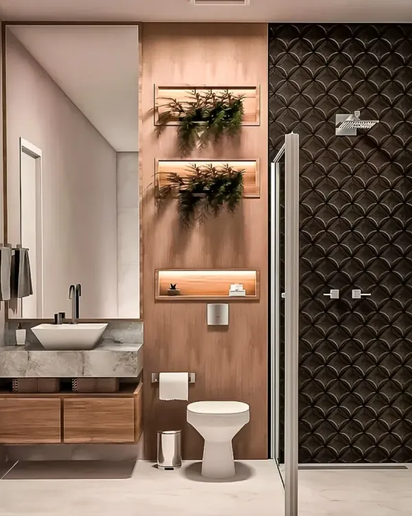 This bathroom design blends natural and modern elements with a wood-paneled wall, a marble-topped vanity, and a striking fish-scale tile pattern in the shower. The recessed, lit-up shelves add both storage and ambiance.