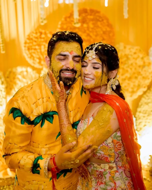 The quintessential Haldi shot. This photo captures the pure joy and playful mess of the ceremony, a moment of love and laughter that is truly priceless.