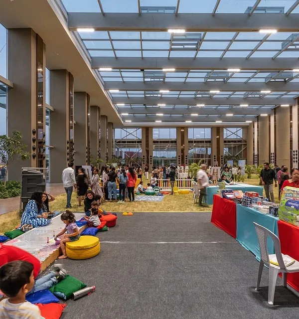 We designed this 40-foot-high glass pavilion to completely blur the line between indoors and outdoors. It allows for community events on a natural lawn while being protected from the elements, fostering a unique connection between people and nature.
