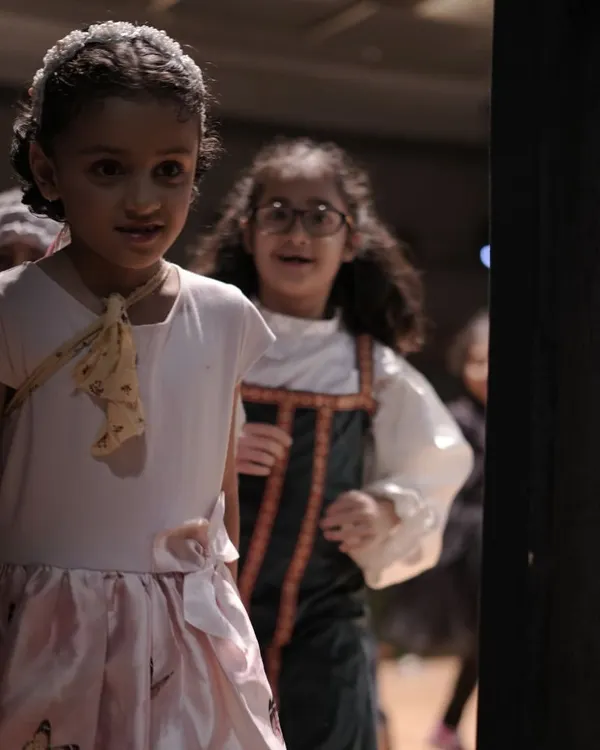 The nervous excitement in the wings just before the show begins. These moments of anticipation and quiet support are where friendships are forged and confidence is built.
