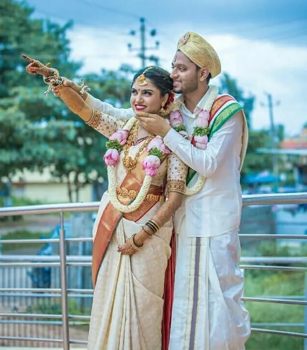 This is the result I work towards: a perfect couple, happy and ready to start their new life together. This photo captures the joy and traditional beauty of a Gowda wedding, a moment made possible through a careful and personal matchmaking process.