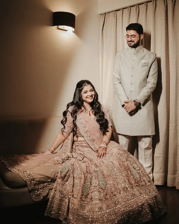 An elegant and formal portrait of the couple for their Roka ceremony. Her intricate lehenga and his classic sherwani are beautifully captured in this poised and graceful shot.