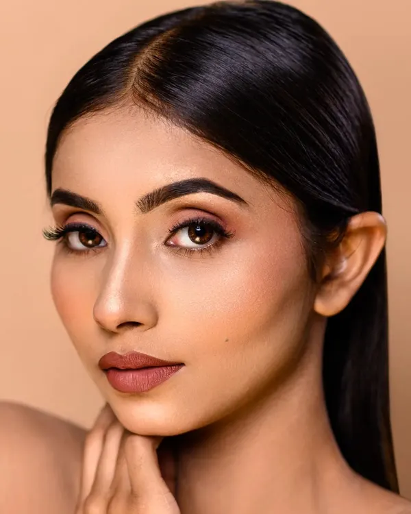 A flawless beauty shot. The focus is on the clean, minimal makeup and the model's perfect skin, achieved with professional retouching. This is ideal for a makeup artist's portfolio.
