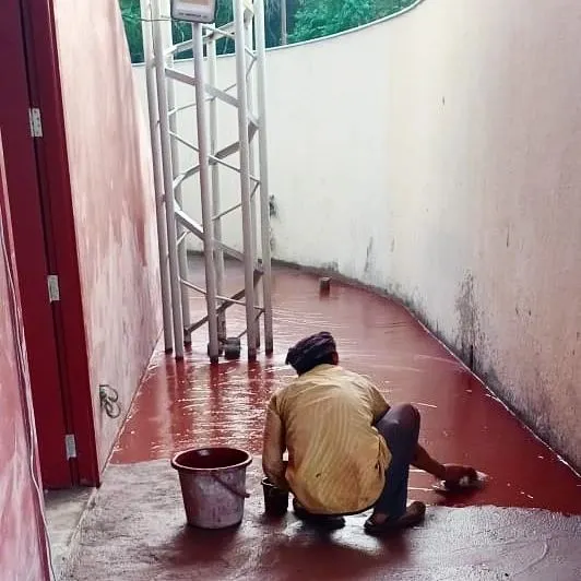 An artisan applies red oxide flooring by hand at the TAPMI Centre. This was a personal exploration for us, working closely with local craftspeople to revive this traditional technique at a large scale.
