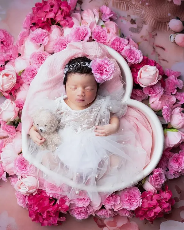This is what dreams are made of. For this session with a precious five day old angel, we created a heart-shaped bed of soft pink flowers to show just how delicate and beautiful newborns are. This portrait has all my heart.