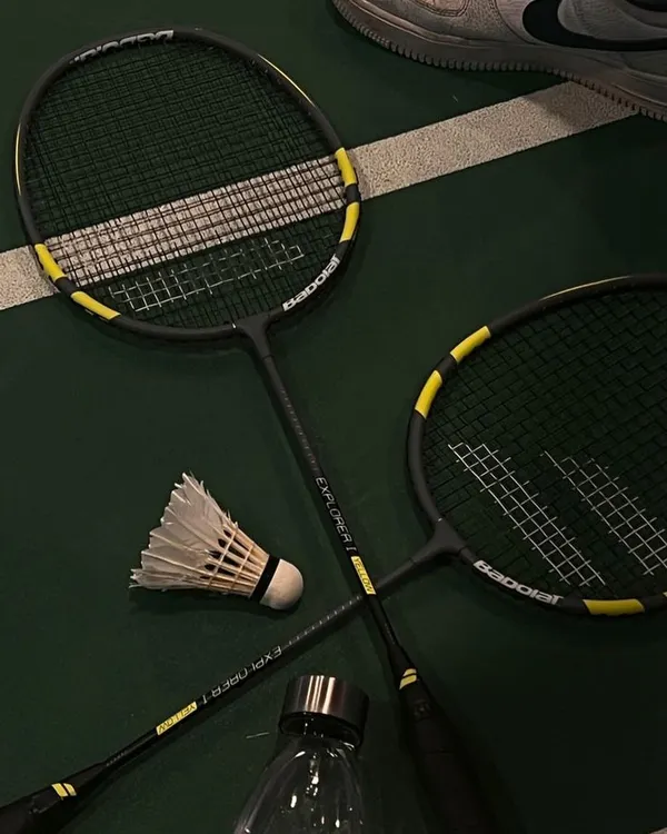 The tools of our favorite trade. A couple of rackets, a shuttle, and a water bottle to stay hydrated.
