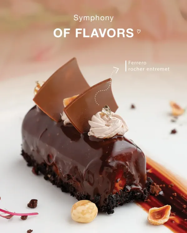 Indulgence redefined. Our Ferrero Rocher Entremet is a luxurious creation featuring layers of rich chocolate, crunchy hazelnut, and velvety mousse, finished with a glossy glaze and delicate gold leaf.