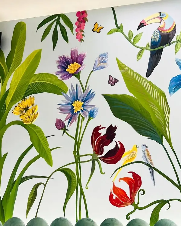 A close-up of the tropical mural, showing the detail on the toucan and the variety of flowers. Each element was hand-painted to create a lush, immersive jungle feel for a child's bedroom.