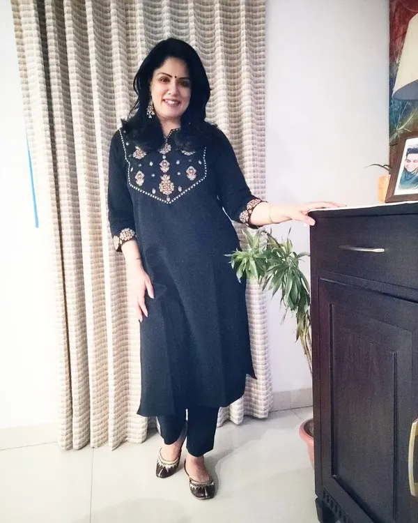 A full-length view of my comfortable black kurta set, paired with traditional juttis. It's a go-to outfit that is both elegant and easy to wear.