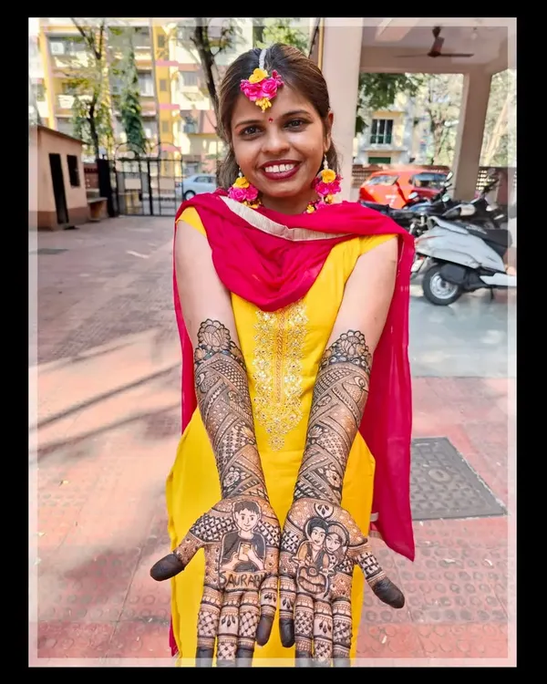 My beautiful bride Darshana, glowing with happiness on her mehendi day. Her custom design tells her unique story.