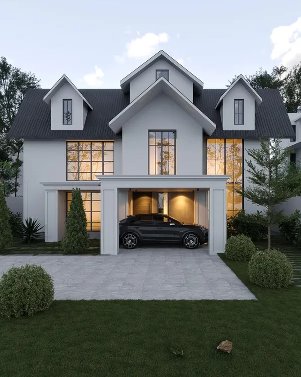 A new project in Palakad with a classic colonial-inspired design. This home features a symmetrical white facade, large windows, and distinctive dormer windows on the upper floor.