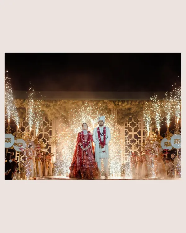 A grand finale for a grand wedding. The fireworks and cold pyros create a spectacular backdrop for the couple's stage moment, a truly cinematic celebration.