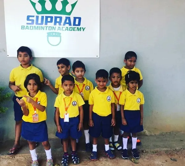 A group of our youngest players from a local school posing proudly outside the academy. Our kids' badminton classes are a great way for them to build confidence and make new friends.