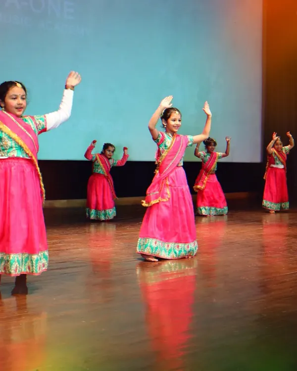 Our students shining on stage during our annual 'Pehal' showcase. This group performance highlights the beautiful costumes, synchronized movements, and pure joy that dance brings.