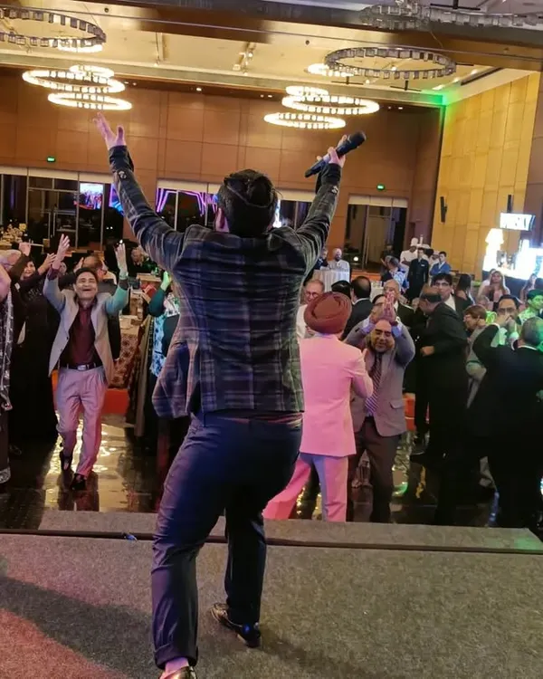 This is my favorite view, from the stage looking out at a dance floor full of happy people. As your anchor, I make it my mission to ensure every single guest feels like part of the celebration.