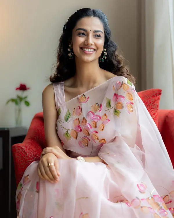 A full view of the hand-painted Picchika saree. The delicate organza fabric and soft floral pattern create a look of pure elegance and grace.